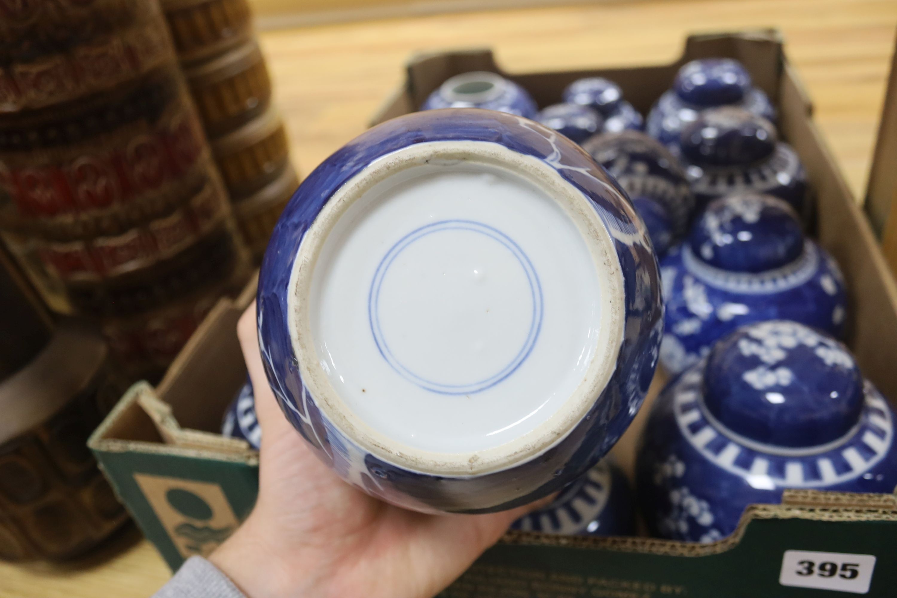 Fourteen Chinese blue and white 'prunus' jars, some with covers